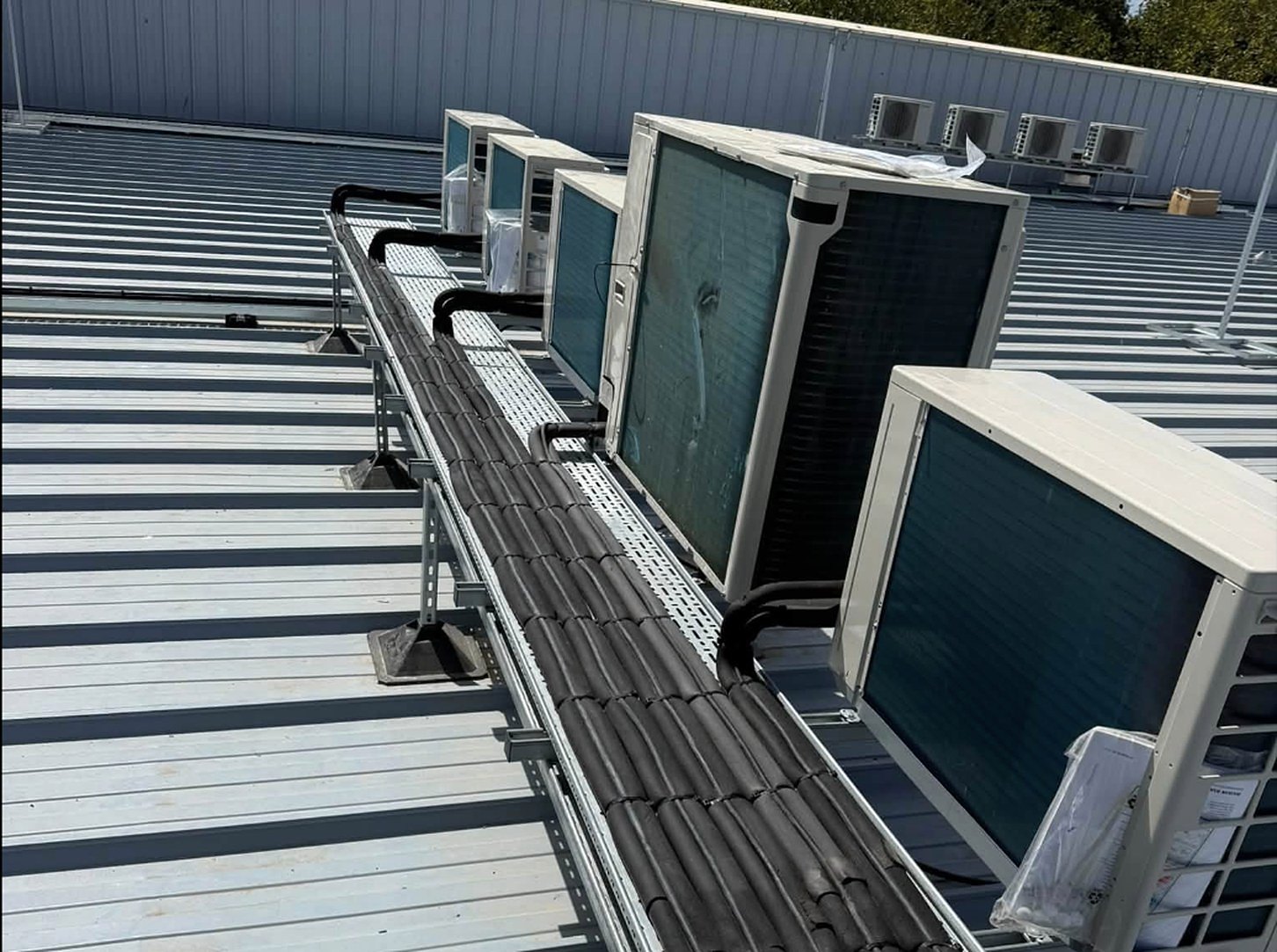 Row of condenser units installed by Wilson Refrigeration on a commercial roof in Rotherham