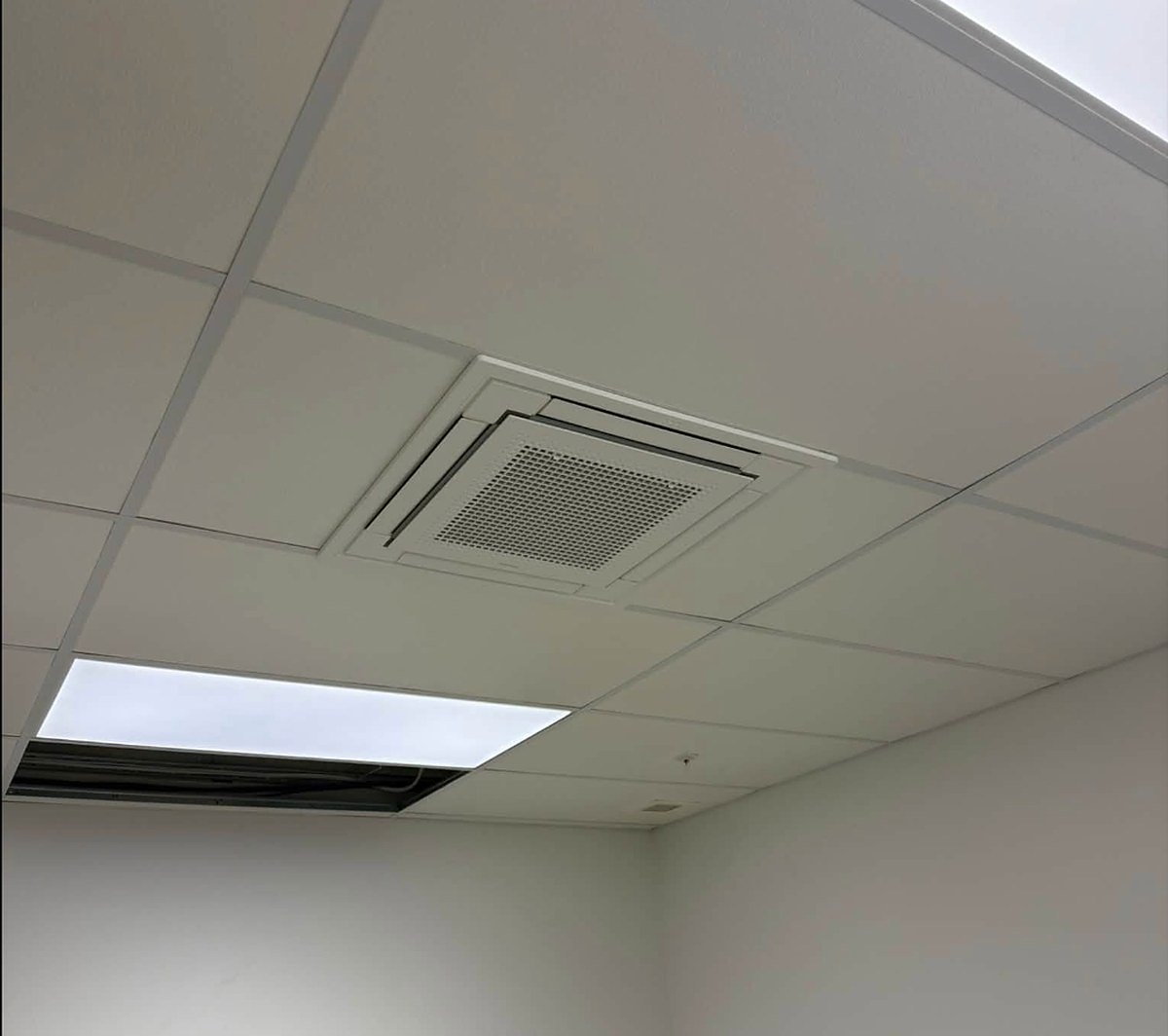Ceiling cassette air conditioning unit fitted in a suspended ceiling by Wilson Refrigeration